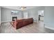 Cozy living room with a classic fireplace, stylish ceiling fan, and view into the adjacent kitchen at 137 Cotillion Cres, Summerville, SC 29483