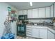 Compact kitchen offers white cabinets, black appliances, and ample storage space at 14 Lockwood Dr # 9K, Charleston, SC 29401