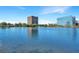 Scenic view of a tranquil lake reflecting a high-rise building and clear blue sky at 14 Lockwood Dr # 9K, Charleston, SC 29401