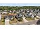 Aerial view of a residential neighborhood with well-maintained homes, green spaces, and tree-lined streets under a sunny sky at 144 Marinella Dr, Goose Creek, SC 29445