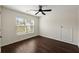 Bright bedroom featuring a ceiling fan, a window for natural light, and sleek wood flooring, great for relaxing at 144 Marinella Dr, Goose Creek, SC 29445