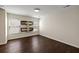 A spacious room with two windows, decorative wall shelves, and wood flooring, perfect for living or storage at 144 Marinella Dr, Goose Creek, SC 29445