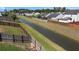 Aerial view of a drainage canal surrounded by grassy banks and fencing in a residential neighborhood, essential for water management at 144 Marinella Dr, Goose Creek, SC 29445