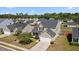 Inviting two-story home featuring a well-manicured lawn, attached two-car garage, and a charming covered front porch at 144 Marinella Dr, Goose Creek, SC 29445