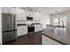 Modern kitchen boasts stainless appliances, white cabinetry, a stylish island, and ample counter space for cooking at 144 Marinella Dr, Goose Creek, SC 29445