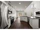 Bright kitchen with stainless steel appliances, white cabinetry, stylish island, and seamless flow to the living area at 144 Marinella Dr, Goose Creek, SC 29445