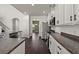 Bright kitchen boasts modern stainless appliances, dark counters and wood floors with an open layout at 144 Marinella Dr, Goose Creek, SC 29445