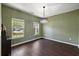 Inviting living room features large windows, hardwood floors and stylish chandelier at 144 Marinella Dr, Goose Creek, SC 29445