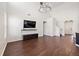 Open-concept living area with soaring ceilings, hardwood floors, modern lighting, media center, and staircase access at 144 Marinella Dr, Goose Creek, SC 29445