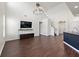 Bright and open living area with hardwood floors, soaring ceilings, modern lighting, media center, and staircase access at 144 Marinella Dr, Goose Creek, SC 29445
