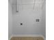 A bright laundry room features tile flooring, wire racks, and utility connections at 145 Taylor Cir, Goose Creek, SC 29445