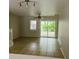 Open living area with tile floors, fan, and sliding door access to the outdoors at 145 Taylor Cir, Goose Creek, SC 29445