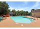 Community pool with poolside chairs, tables, and umbrellas under a sunny sky at 145 Taylor Cir, Goose Creek, SC 29445
