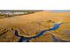 Scenic aerial view featuring a wooden bridge, meandering streams, and expansive marshland, offering a glimpse of the landscape at 1472 Longspur Dr, Mount Pleasant, SC 29466