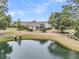 Inviting home featuring a scenic pond, lush landscaping, and a charming screened porch for outdoor enjoyment at 1472 Longspur Dr, Mount Pleasant, SC 29466