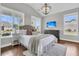 Bedroom featuring wood floors, neutral walls, large windows, chandelier and a television at 1472 Longspur Dr, Mount Pleasant, SC 29466
