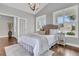 Vaulted ceiling bedroom featuring a bed, wood floors, and windows overlooking the front yard at 1472 Longspur Dr, Mount Pleasant, SC 29466