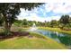 Scenic community pond with a fountain, lush greenery, and landscaping at 1472 Longspur Dr, Mount Pleasant, SC 29466