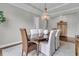 Elegant dining room with a wood table, chandelier, and neutral decor at 1472 Longspur Dr, Mount Pleasant, SC 29466