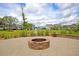 Brick fire pit area with water view, great for gathering, with seating around the brick patio at 1472 Longspur Dr, Mount Pleasant, SC 29466