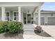 Charming home front porch with gray siding, white columns, and decorative plants enhancing curb appeal at 1472 Longspur Dr, Mount Pleasant, SC 29466