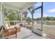 Screened porch featuring a seating area and offering views of a nearby pond at 1472 Longspur Dr, Mount Pleasant, SC 29466