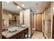 Bathroom featuring dual glass bowl sinks, granite countertop, and large mirror at 150 Bee St # 507, Charleston, SC 29401