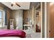 Comfortable bedroom with a view, including a functional workspace, exposed ceiling elements, and stylish decor at 150 Bee St # 507, Charleston, SC 29401