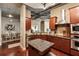 Modern kitchen featuring dark wood cabinets, stainless steel appliances, and granite countertops, with an island prep space at 150 Bee St # 507, Charleston, SC 29401