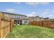 Wide-open backyard with lush green lawn and wood fence, offering space and privacy at 152 Kirkland St, Goose Creek, SC 29445