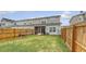 Private backyard with lush grass, wooden fence, and partially covered porch at 152 Kirkland St, Goose Creek, SC 29445
