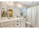 This bathroom includes a double vanity, modern fixtures, plenty of natural light, and a shower and tub at 152 Kirkland St, Goose Creek, SC 29445