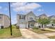 Charming two-story home with gray siding, well-manicured lawn, and an attached one car garage at 152 Kirkland St, Goose Creek, SC 29445