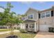 Charming two-story home with gray siding, well-manicured lawn, and an attached one car garage at 152 Kirkland St, Goose Creek, SC 29445