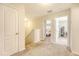 Bright hallway featuring neutral walls, plush carpeting, and inviting views into adjacent rooms at 152 Kirkland St, Goose Creek, SC 29445