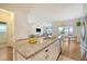 An open-concept kitchen features granite countertops, a large sink, and a view into the living room at 152 Kirkland St, Goose Creek, SC 29445
