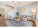 Comfortable living room with soft lighting, a cozy couch, stylish rug, and access to the stairs at 152 Kirkland St, Goose Creek, SC 29445