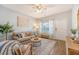 Bright and airy living room featuring a plush couch, area rug, and a large window for natural light at 152 Kirkland St, Goose Creek, SC 29445