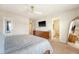 This main bedroom features neutral paint, a ceiling fan, mounted TV, and an ensuite bathroom for added convenience at 152 Kirkland St, Goose Creek, SC 29445