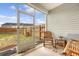 Cozy screened porch with wood furnishings offers a view of the fenced backyard at 152 Kirkland St, Goose Creek, SC 29445