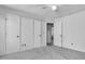 Carpeted bedroom featuring multiple closets and a ceiling fan for added comfort at 153 Corsair St, Summerville, SC 29483