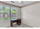 Bedroom featuring a window view, neutral carpet and a dark wood desk by the wall at 153 Corsair St, Summerville, SC 29483