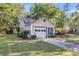 Home exterior view with garage and driveway, showcasing landscaping at 153 Corsair St, Summerville, SC 29483