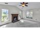 Spacious living room with a brick fireplace, ceiling fan, and multiple windows at 153 Corsair St, Summerville, SC 29483