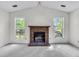 Bright living room featuring a brick fireplace and ample natural light at 153 Corsair St, Summerville, SC 29483