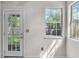 Bright sunroom area with a view to the backyard through a glass paneled door and a window at 153 Corsair St, Summerville, SC 29483