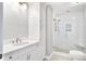 Bright bathroom featuring a glass enclosed shower, white cabinets, and a sleek white countertop sink at 1541 Diamond Blvd, Mount Pleasant, SC 29466