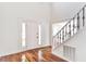 Bright foyer with hardwood floors, staircase, and a white front door at 1541 Diamond Blvd, Mount Pleasant, SC 29466