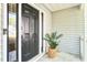 Welcoming front entrance with black door, sidelight, and a charming potted plant at 1541 Diamond Blvd, Mount Pleasant, SC 29466