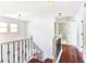 Hallway with iron railings and hardwood floors, with bathroom shown in the background at 1541 Diamond Blvd, Mount Pleasant, SC 29466